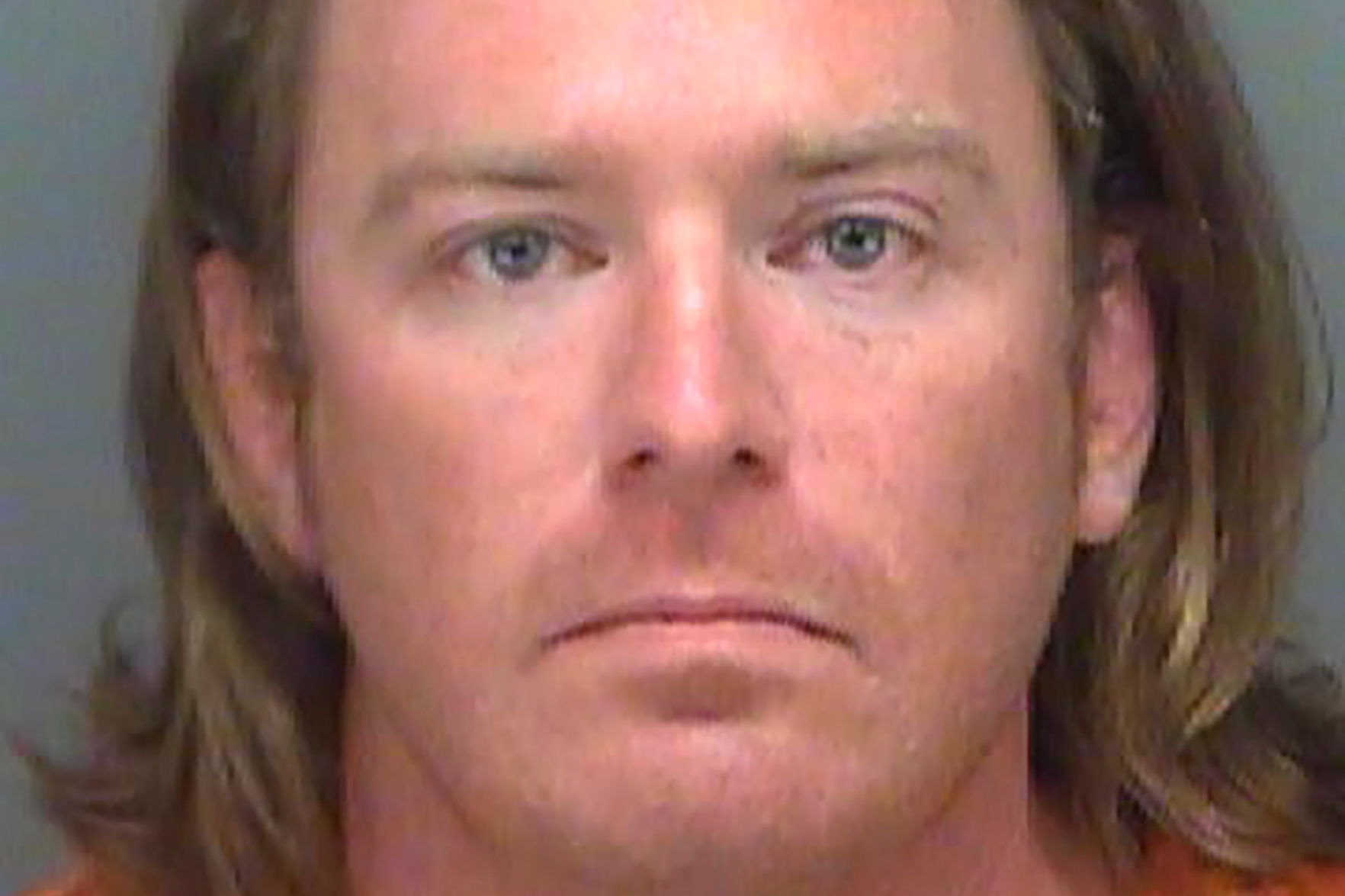 Adam Christian Johnson, who was arrested on a federal warrant, poses in a Pinellas County jail booking photograph
